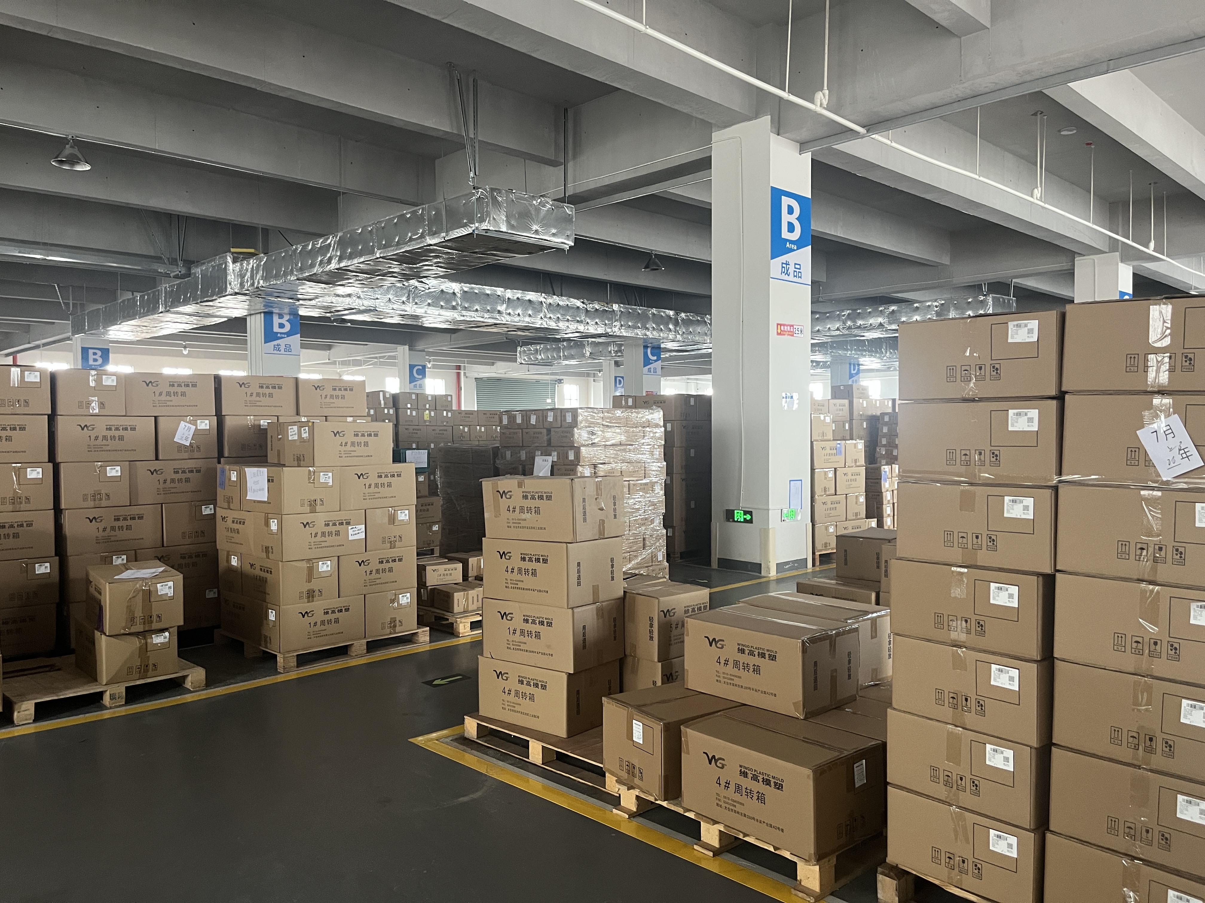 Finished goods warehouse with stacked Wingo Plastic Mold branded cartons